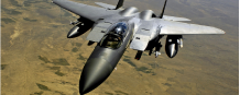 F-15 Eagle fighter jet in flight over desert