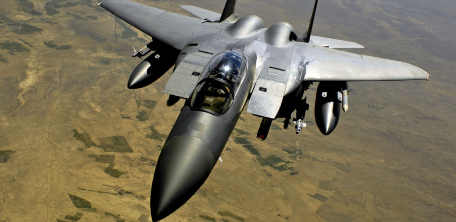 F-15 Eagle fighter jet in flight over desert